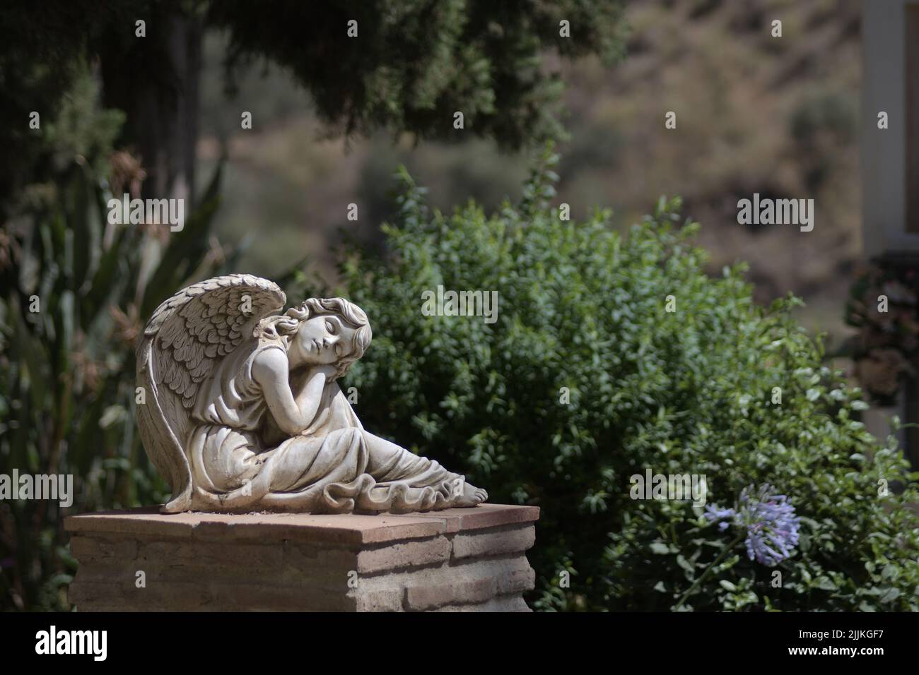 Angel dreaming, statue in the cemetery of Macharaviaya, Spain Stock