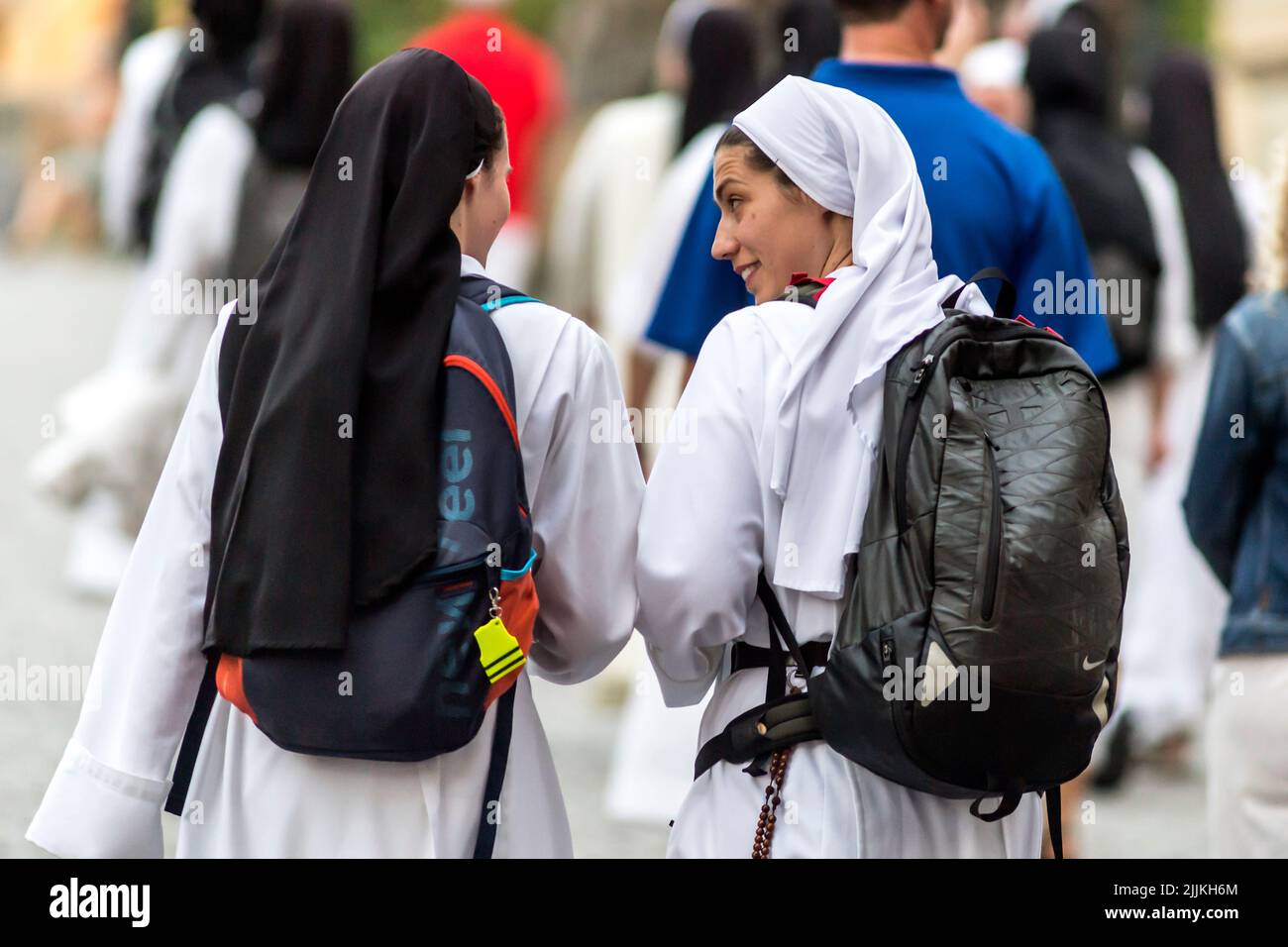 two white nuns walking on the street Stock Photo