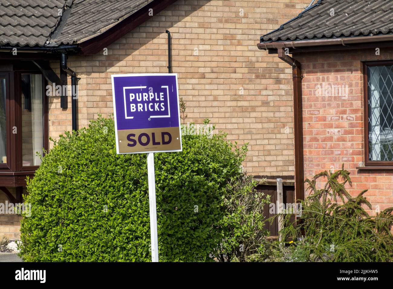 Purple bricks estate agency sign Stock Photo Alamy