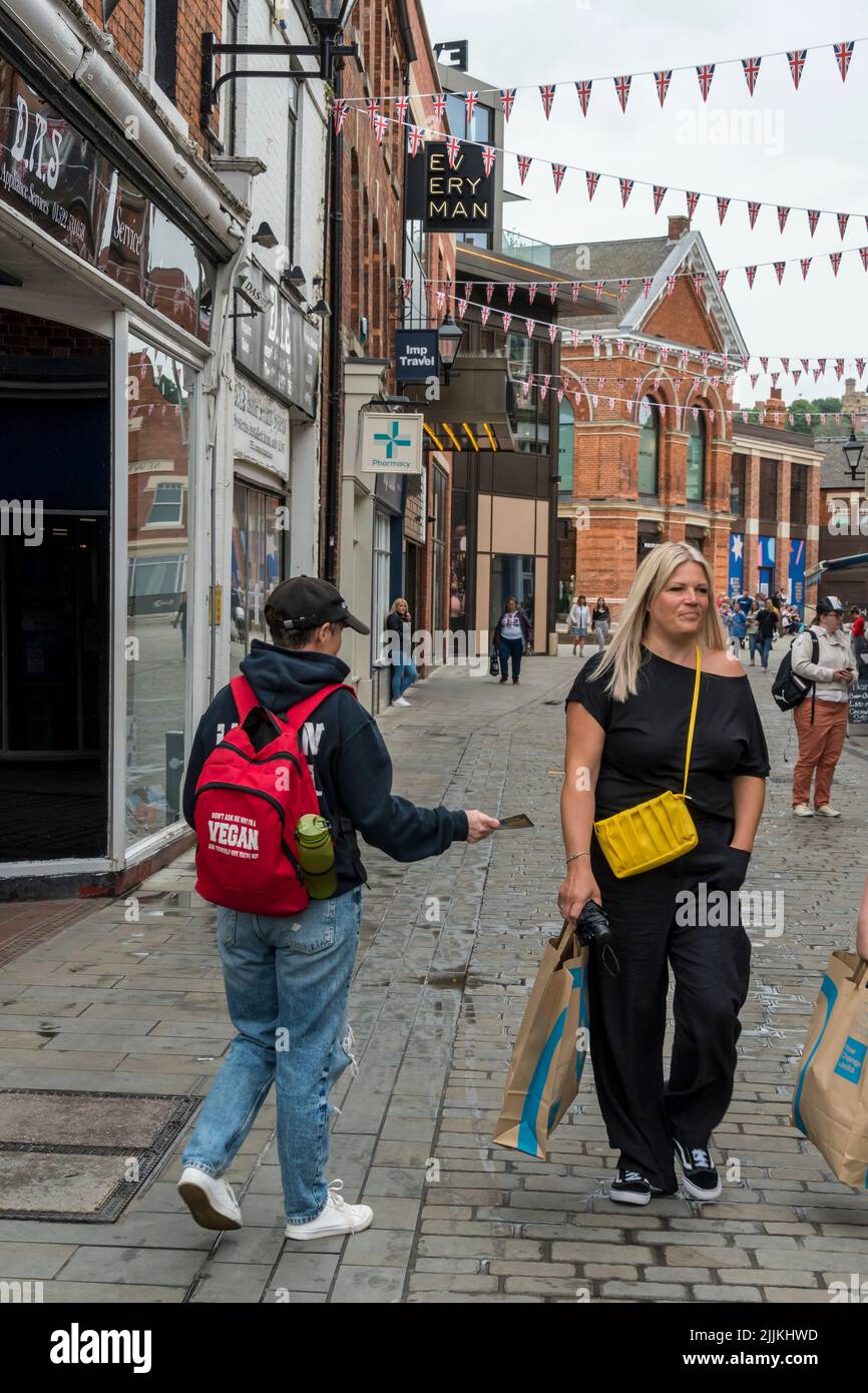 Viva! animal rights protester handing out information leaflets being totally ignored by female pedestrian Sincil street Lincoln city 2022 Stock Photo