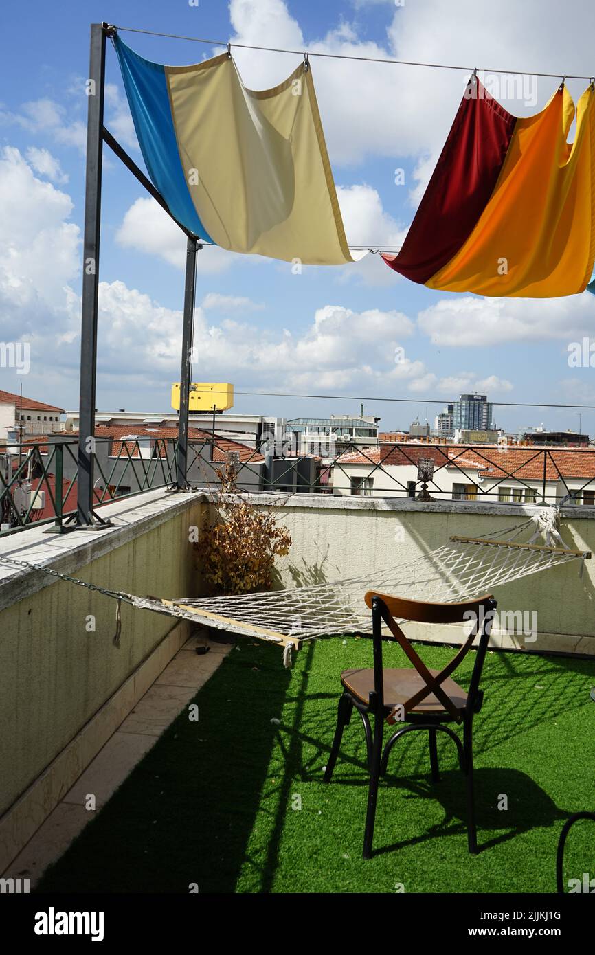 A vertical shot of sun shade nets and hammock in the balcony Stock