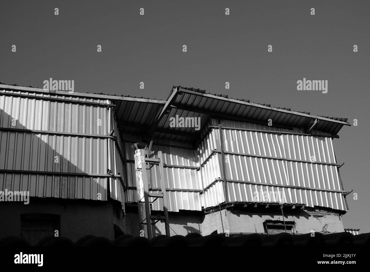A greyscale shot of an old metal building Stock Photo