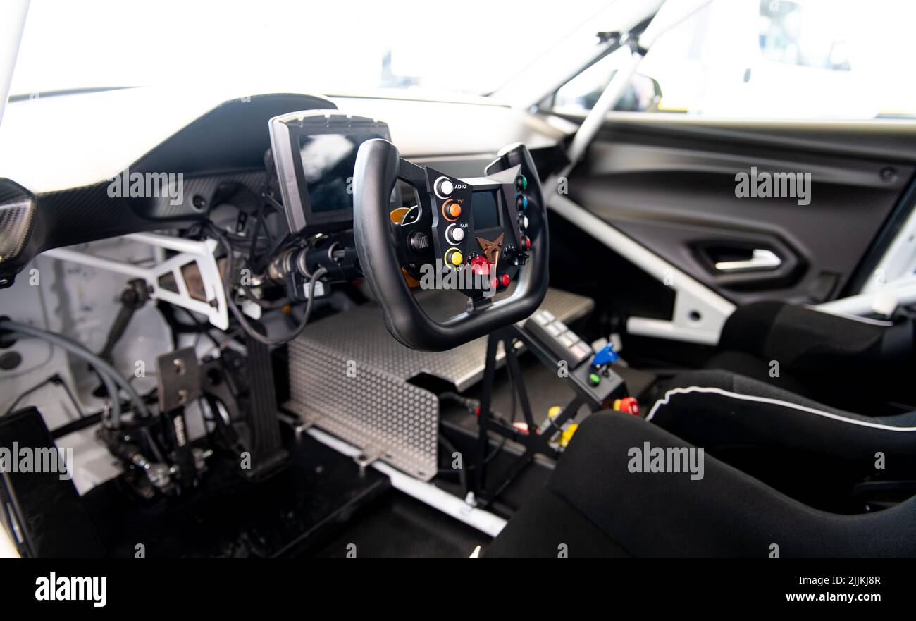 Race car driver seat cockpit, no people steering wheel with knobs and Cupra logo. Vallelunga, Italy, july 24 2022, Race of Italy Stock Photo