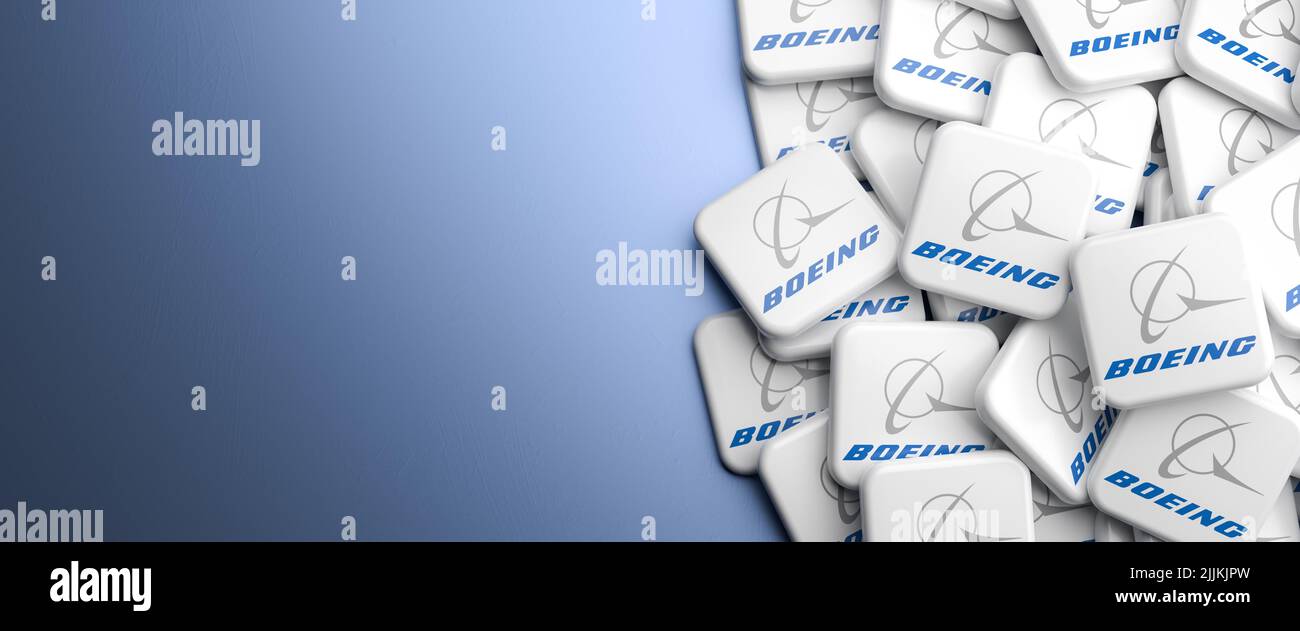 Logos of the manufacturer of airplanes, satellites and rockets Boeing on a heap on a table. Copy space. Web banner format Stock Photo