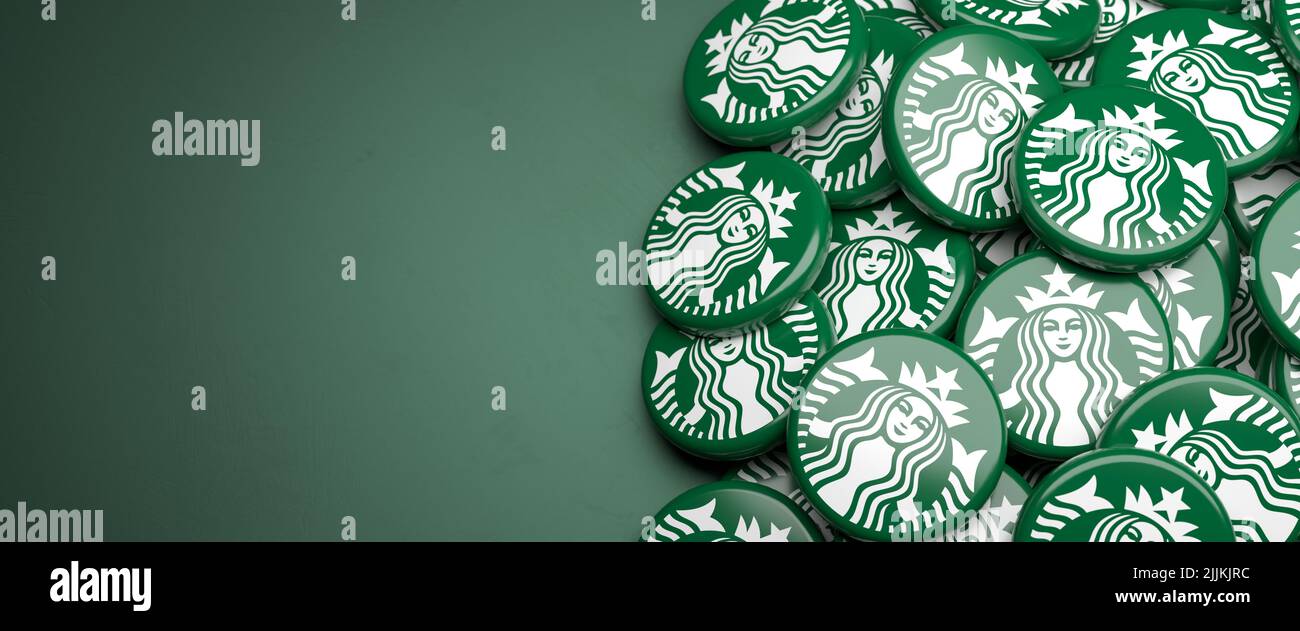 Logos of the coffeehouse chain Starbucks on a heap on a table. Copy space. Web banner format. Stock Photo