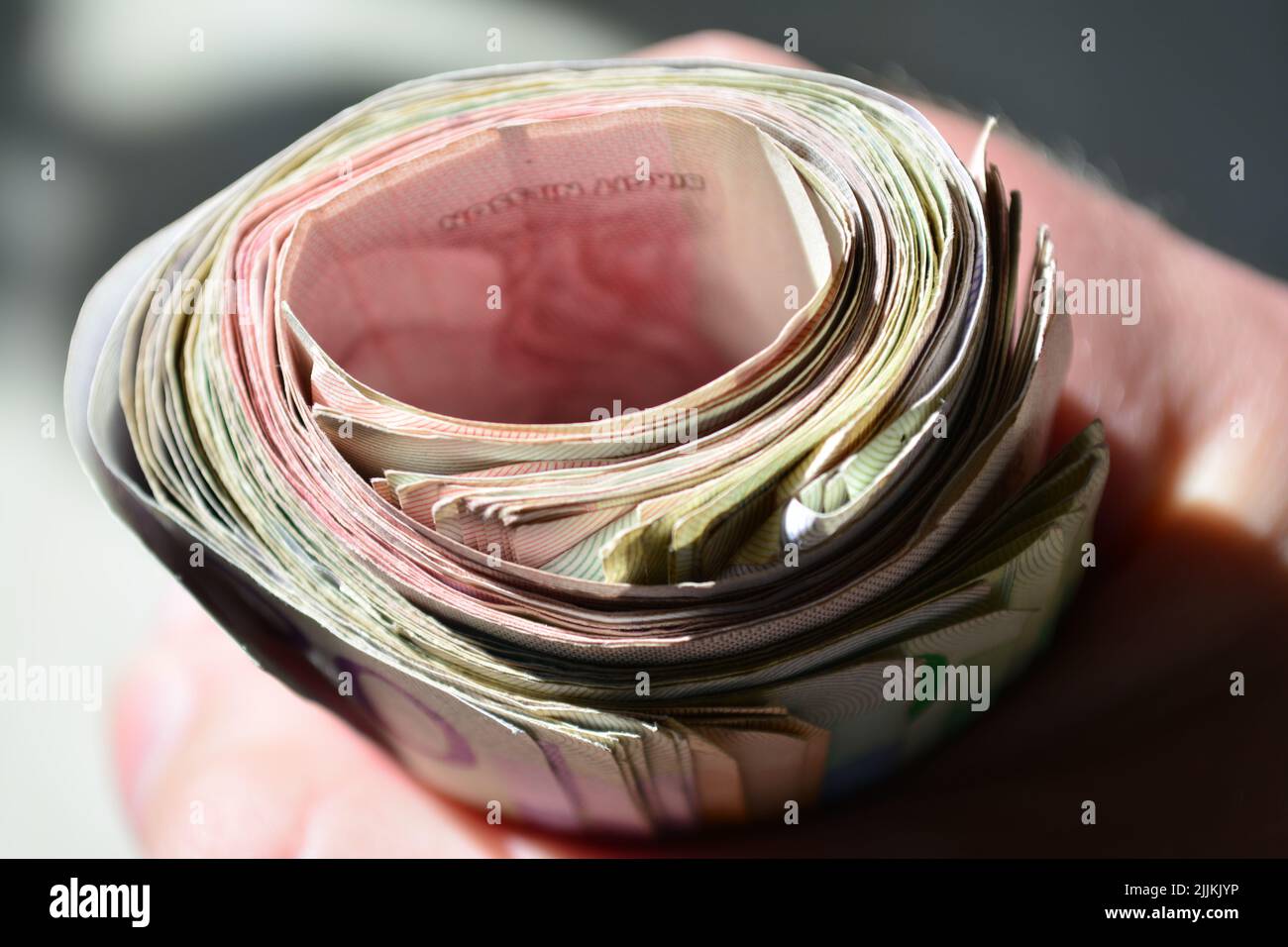 A close-up shot of swirled Swedish banknotes in a hand Stock Photo - Alamy