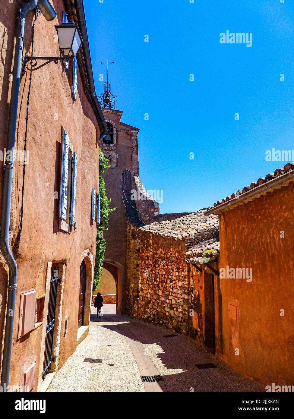 A narrow street with old buildings on a sunny day Stock Photo