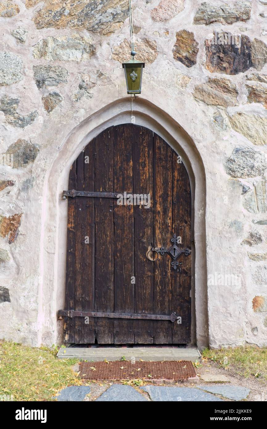 Old wooden door on a stone building Stock Photo - Alamy