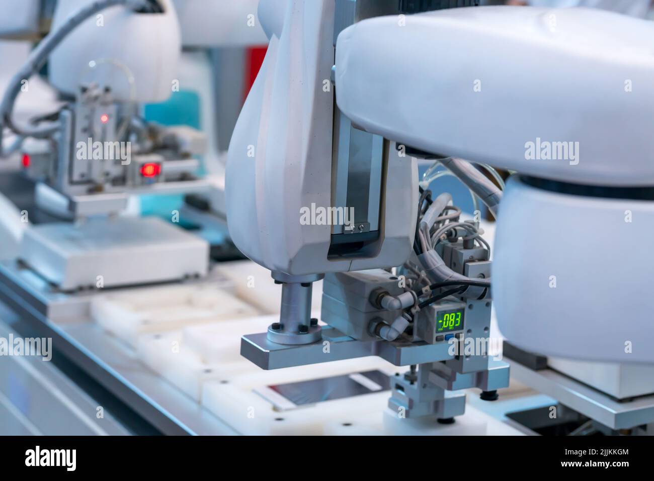 A closeup shot of robotic arms assemble smartphone in modern factory Stock Photo