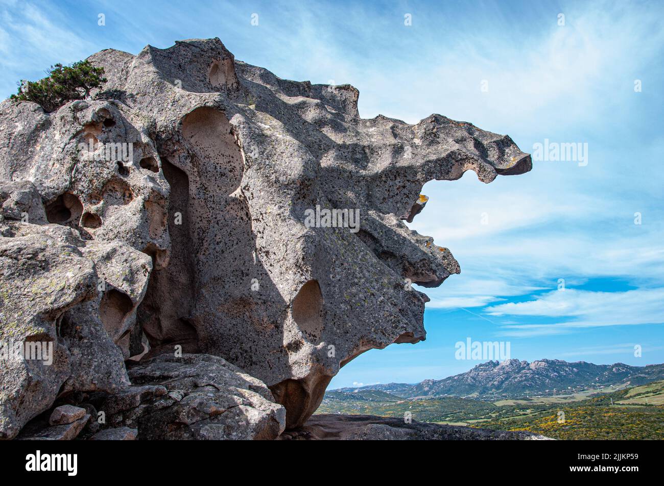 A scenic view of a rock formation outdoors on cloudy sky background Stock Photo
