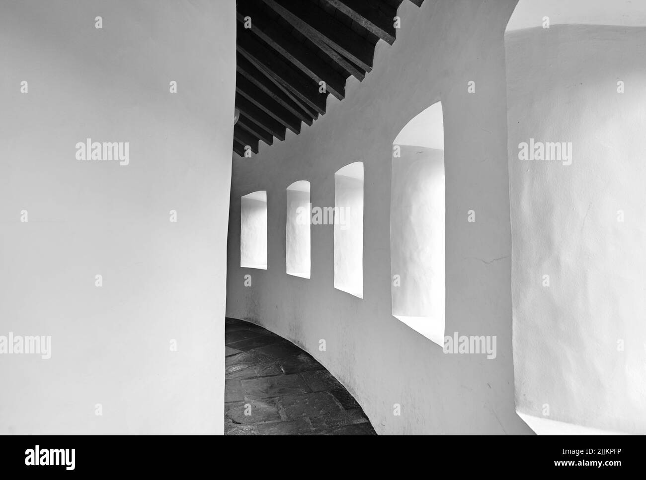 A grayscale of a white painted building with windows Stock Photo