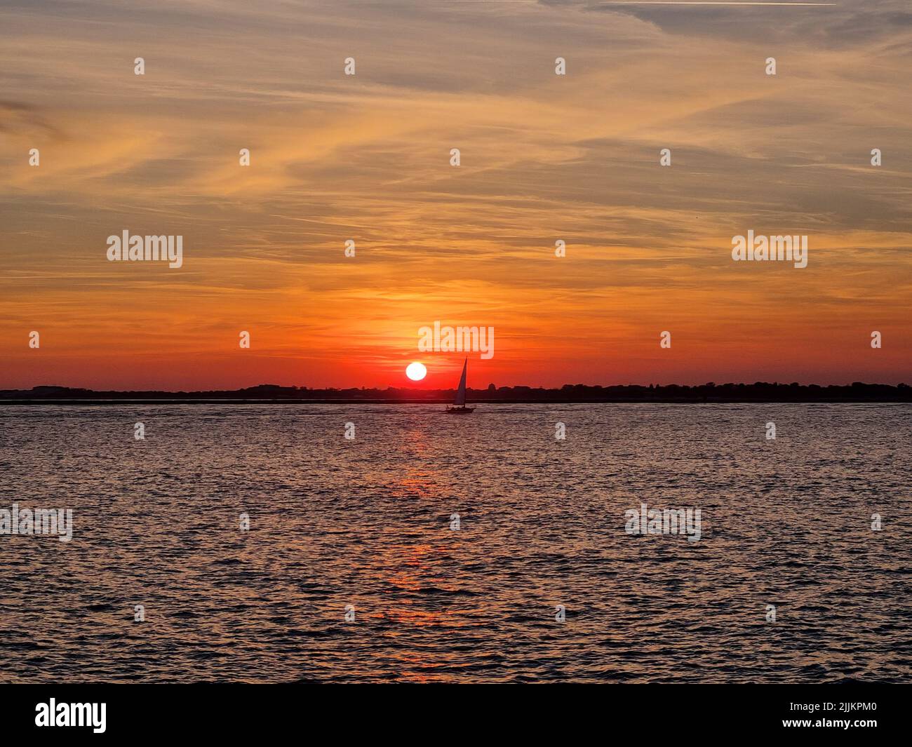A silhouette of boat floating on water during sunset Stock Photo - Alamy