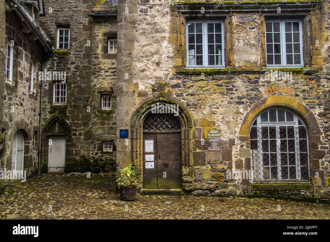The facade of an old building with arched door and window Stock Photo ...