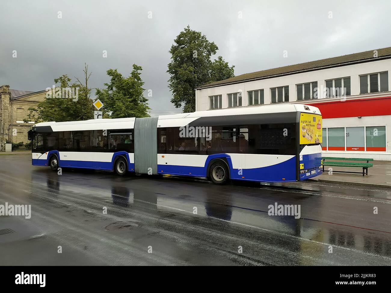 The city bus leaves from the bus stop Stock Photo - Alamy