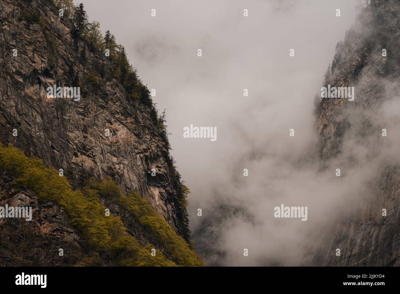 A rocky mountain in the fog Stock Photo
