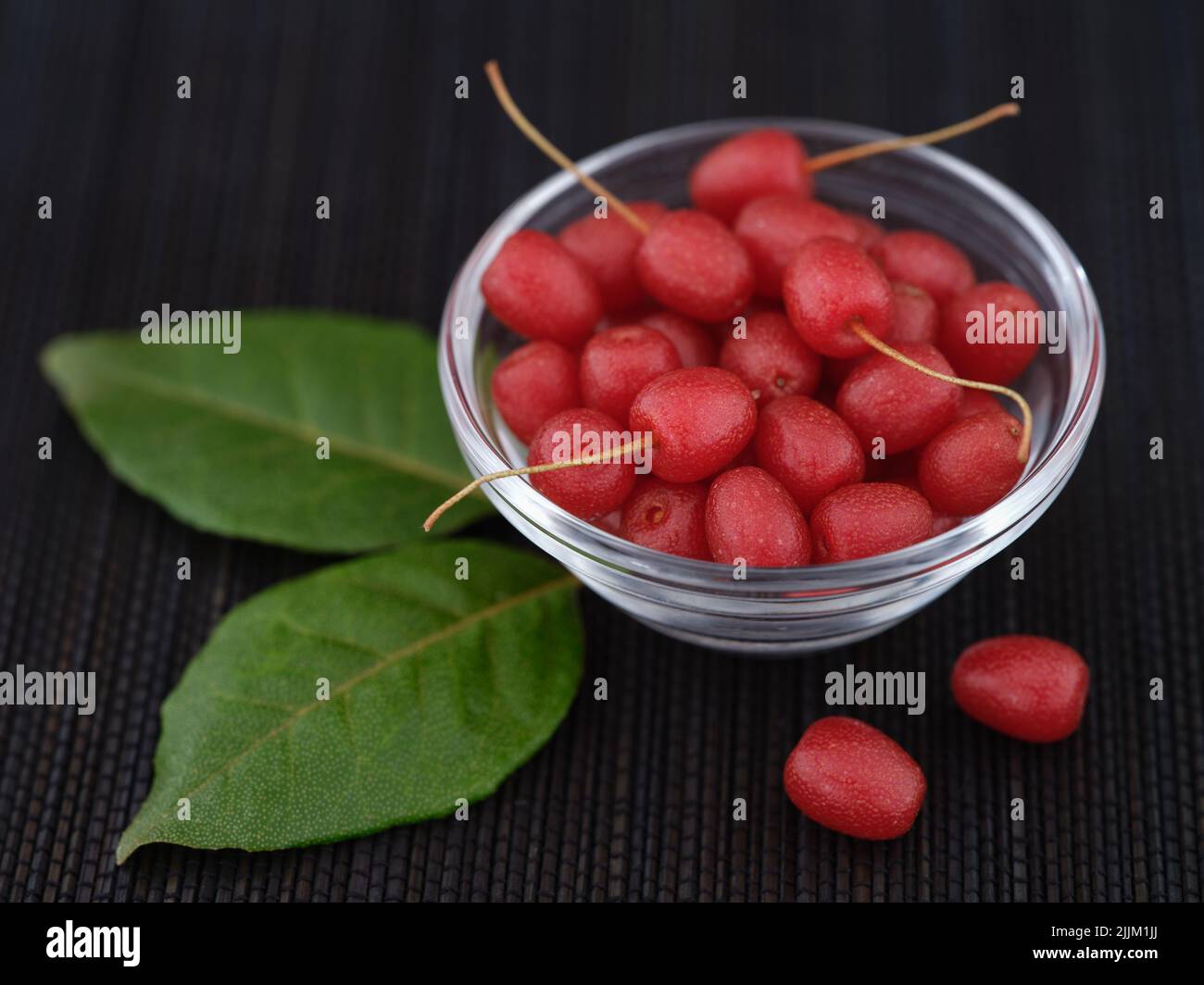 Silverberries (elaeagnus or oleaster) in a glass bowl. Low key. Close up. Stock Photo