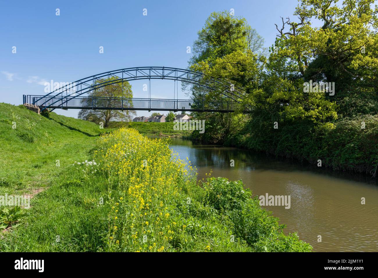 The Millennium Bridge over the River Yeo, also known as the Congresbury Yeo, at Congresbury on a sunny spring day, North Somerset, England. Stock Photo
