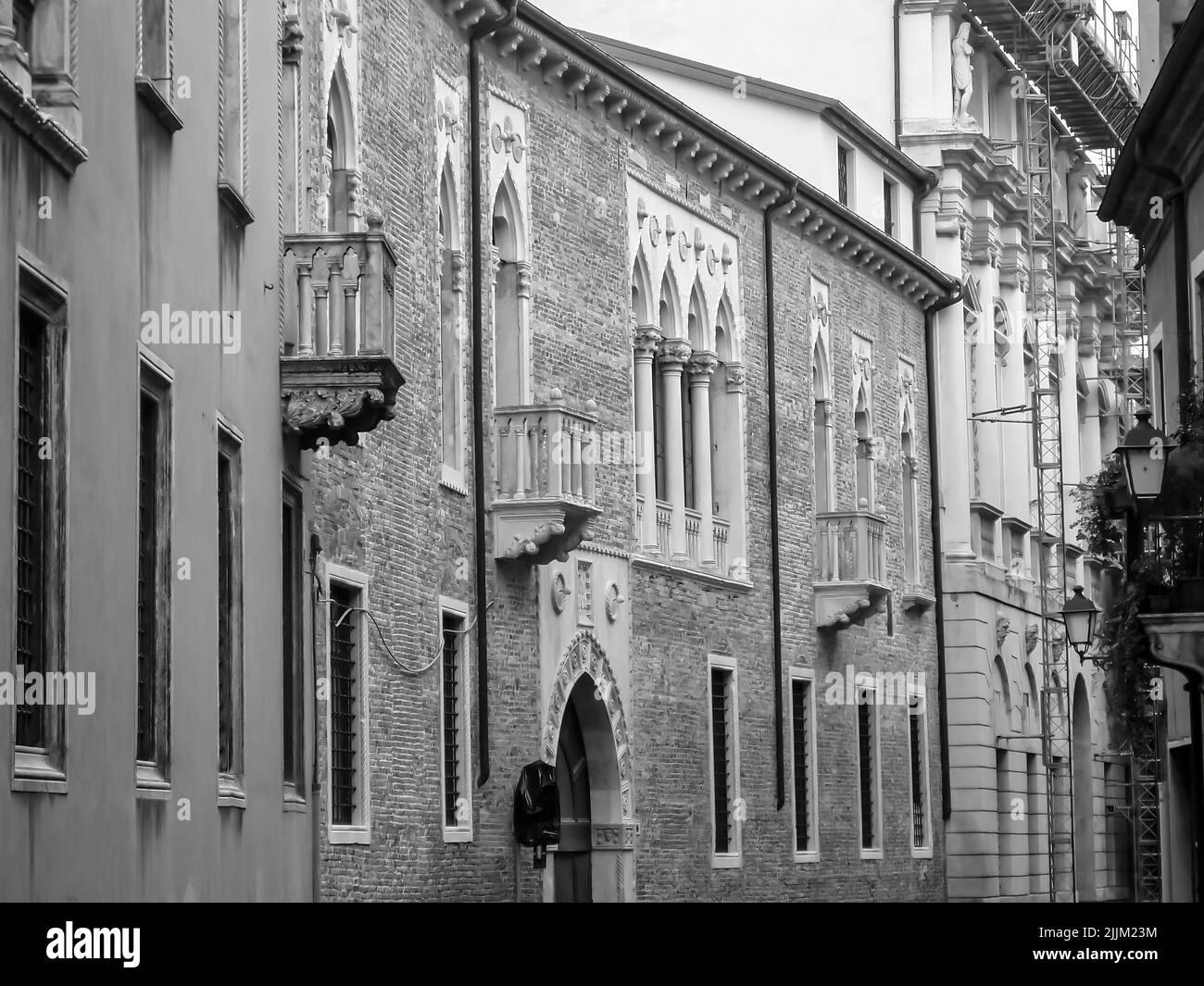 A black and white shot of a beautiful stone buildings with balconies Stock Photo