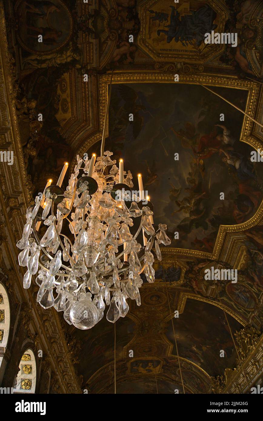 A vertical shot of the ceiling chandelier in the Hall of Mirrors, Palace of Versailles, Paris, France Stock Photo