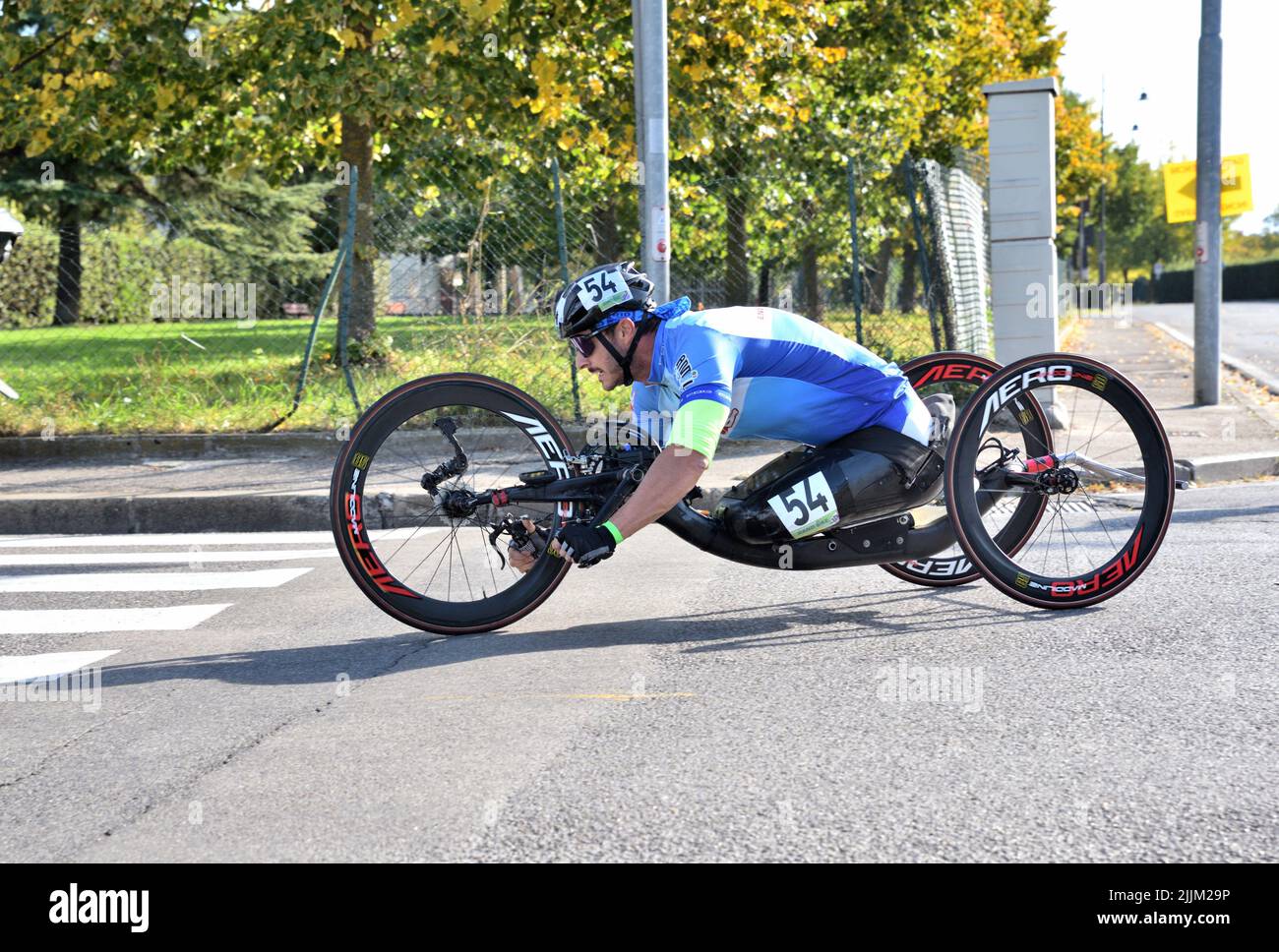A daylight shot of a male driving a handicap technology bike at a