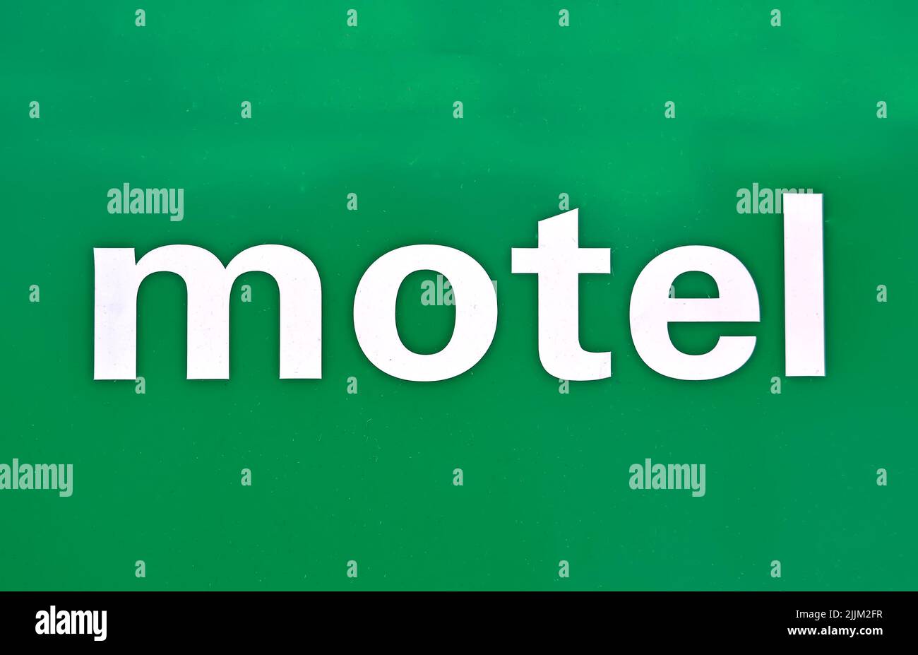 motel message on grunge plastic green surface, modern travel diversity Stock Photo