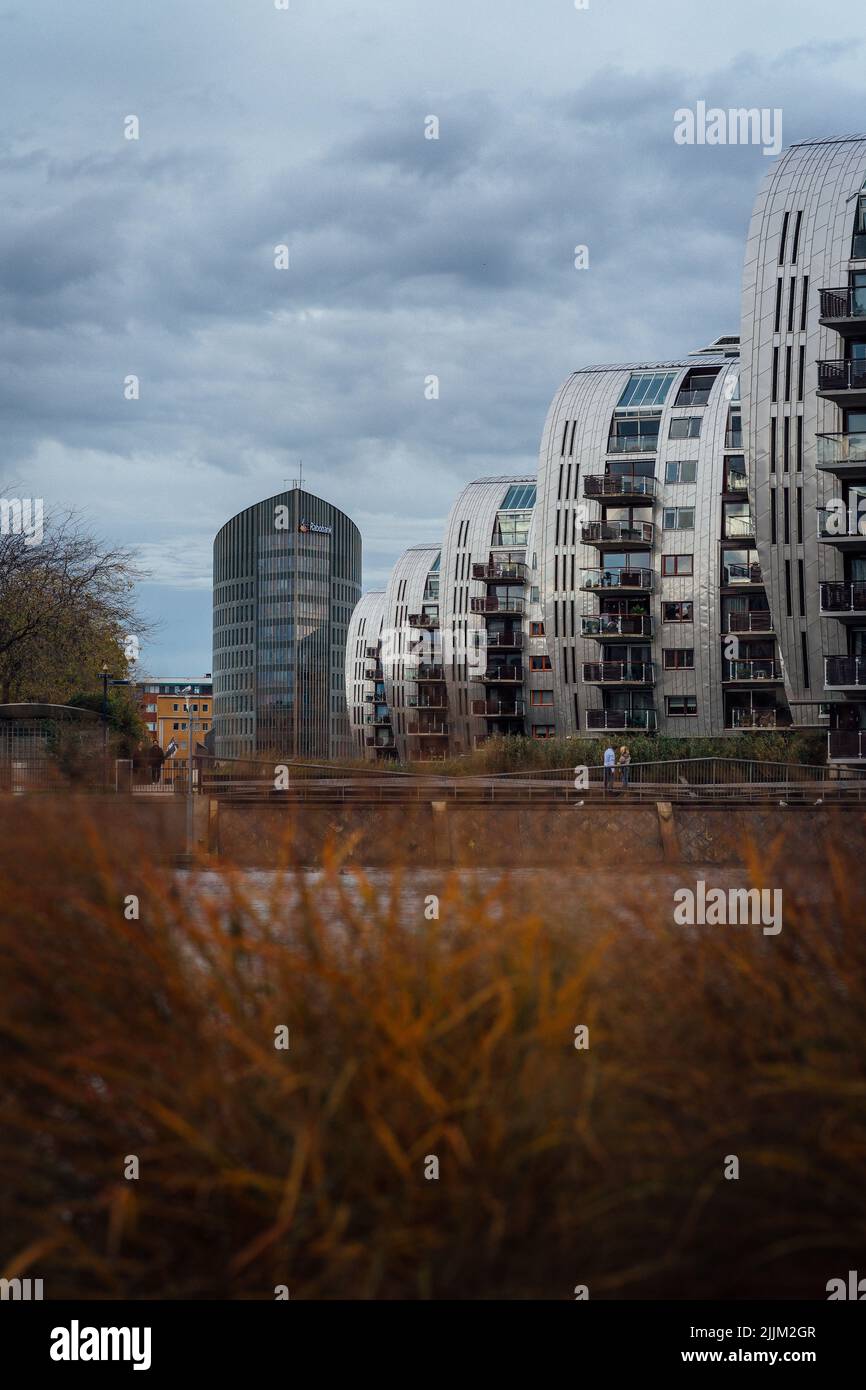 A vertical shot of apartment buildings overlooking a pond in 's-Hertogenbosch, the Netherlands Stock Photo