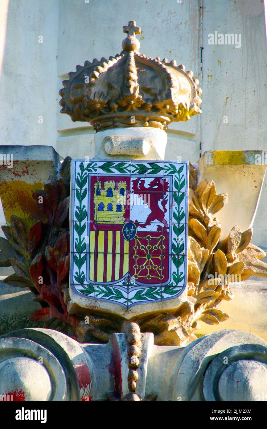 A vertical shot of the Spanish Coat of Arms on a golden sculpture Stock ...