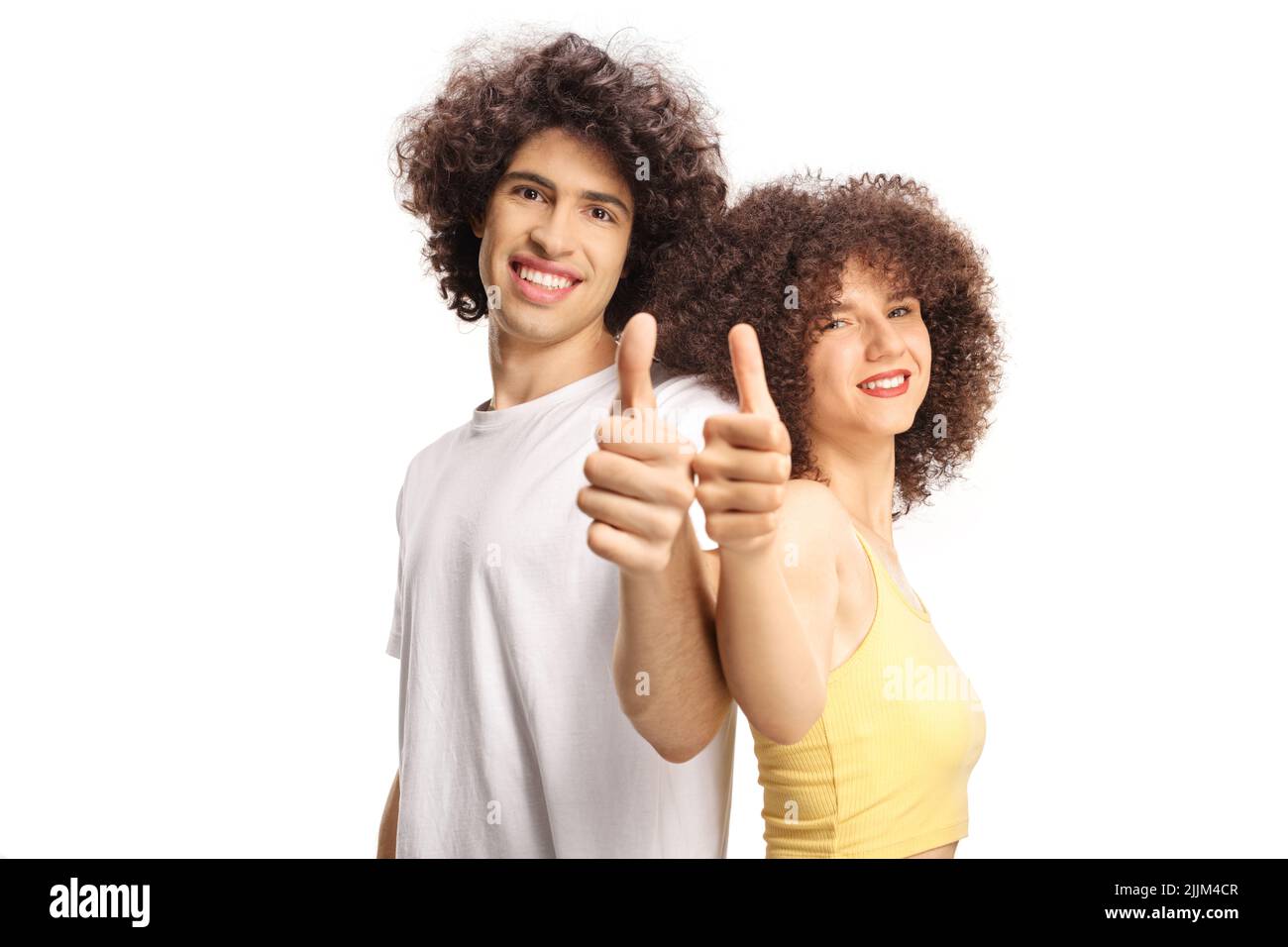 Couple with curly hair smiling and posing back to back with thumbs up isolated on white background Stock Photo