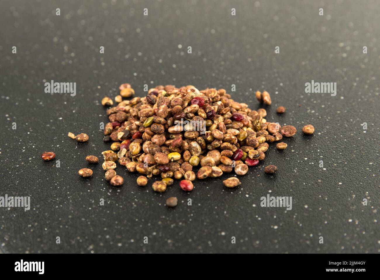 Whole dried sumac berries on a black cutting board Stock Photo Alamy
