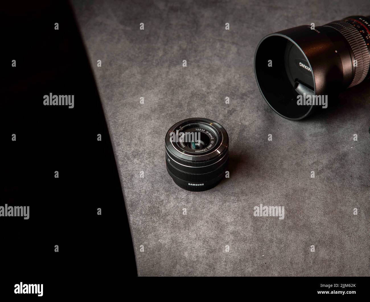 A product shot of Samsung NX 3000 camera with its kit lenses and Samyang 85 mm lens Stock Photo