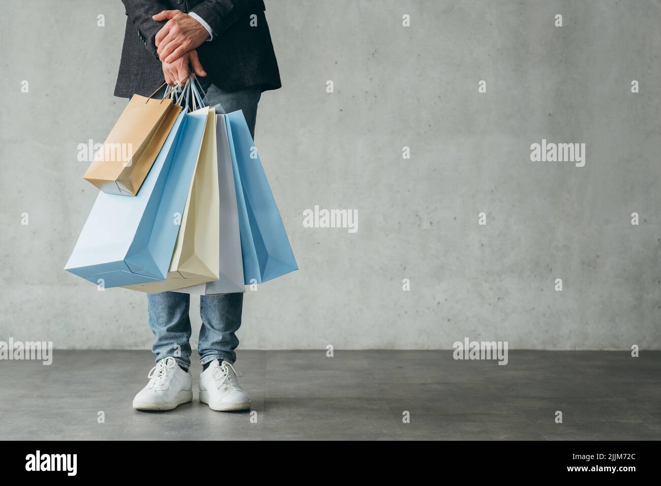 holiday sale shopping consumerism man hold bags Stock Photo