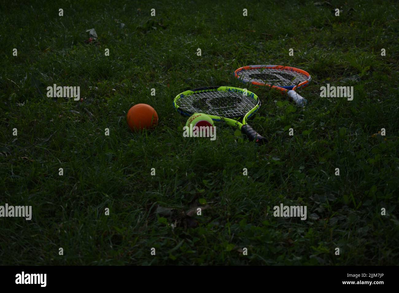 A view of tennis balls and rackets on the grass Stock Photo