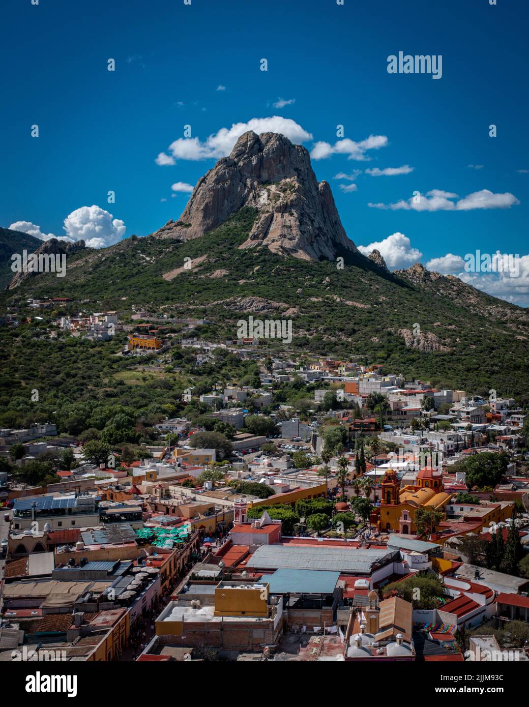 A vertical shot of Bernal's Boulder (Bernal Peak) with a picturesque view of Queretaro city, Mexico Stock Photo