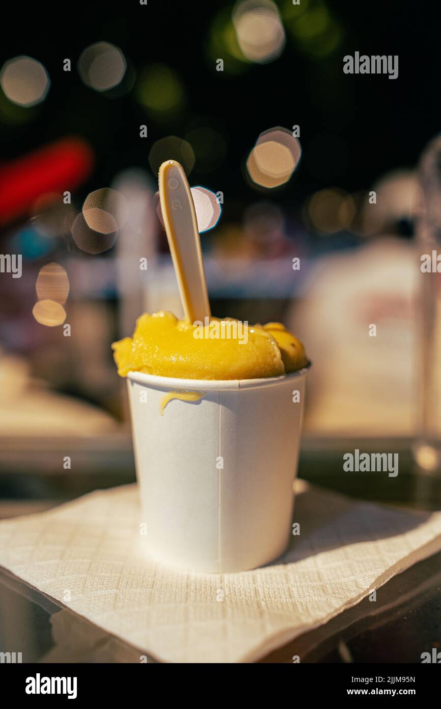 A vertical closeup shot of a dessert ice cream on blurry background Stock Photo