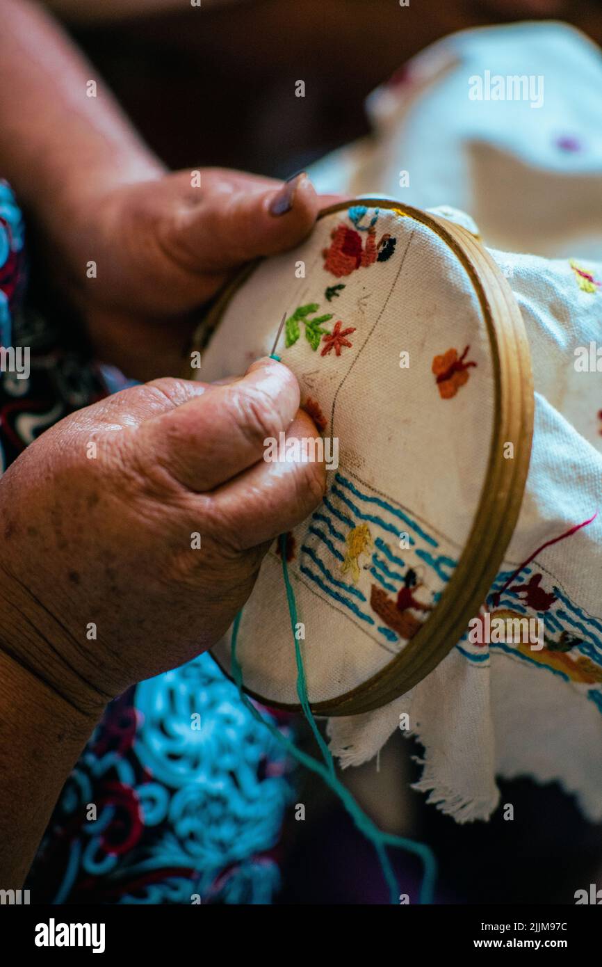 A vertical shot of the process of embroidery done by a professional ...