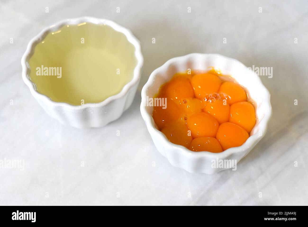 Separated yolk and egg white prepared for baking Stock Photo