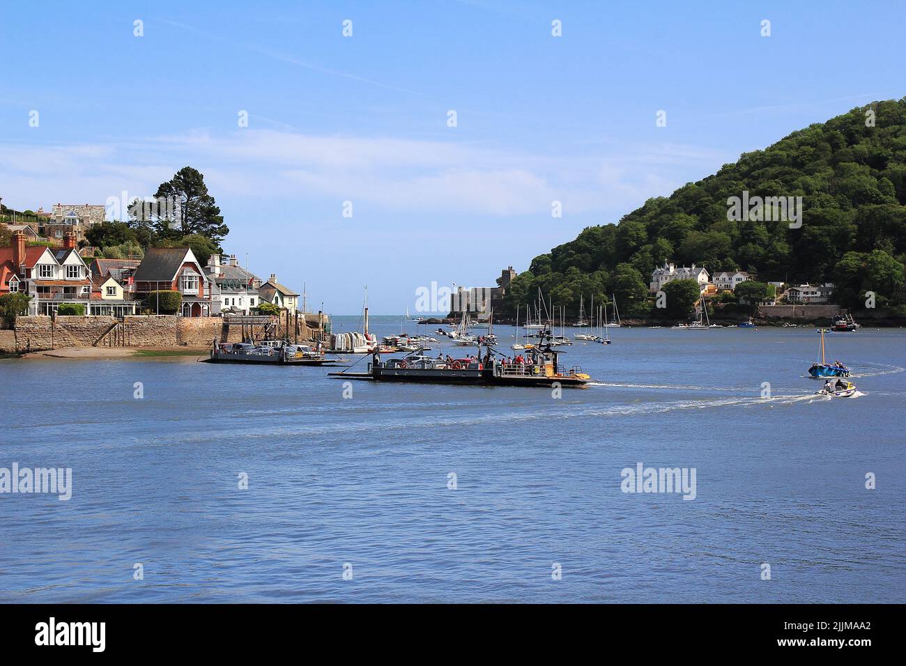 Both lower Dart passenger/car ferries about to pass each other crossing the River  between Kingswear(in picture) on the Eastern bank and Dartmouth Stock Photo