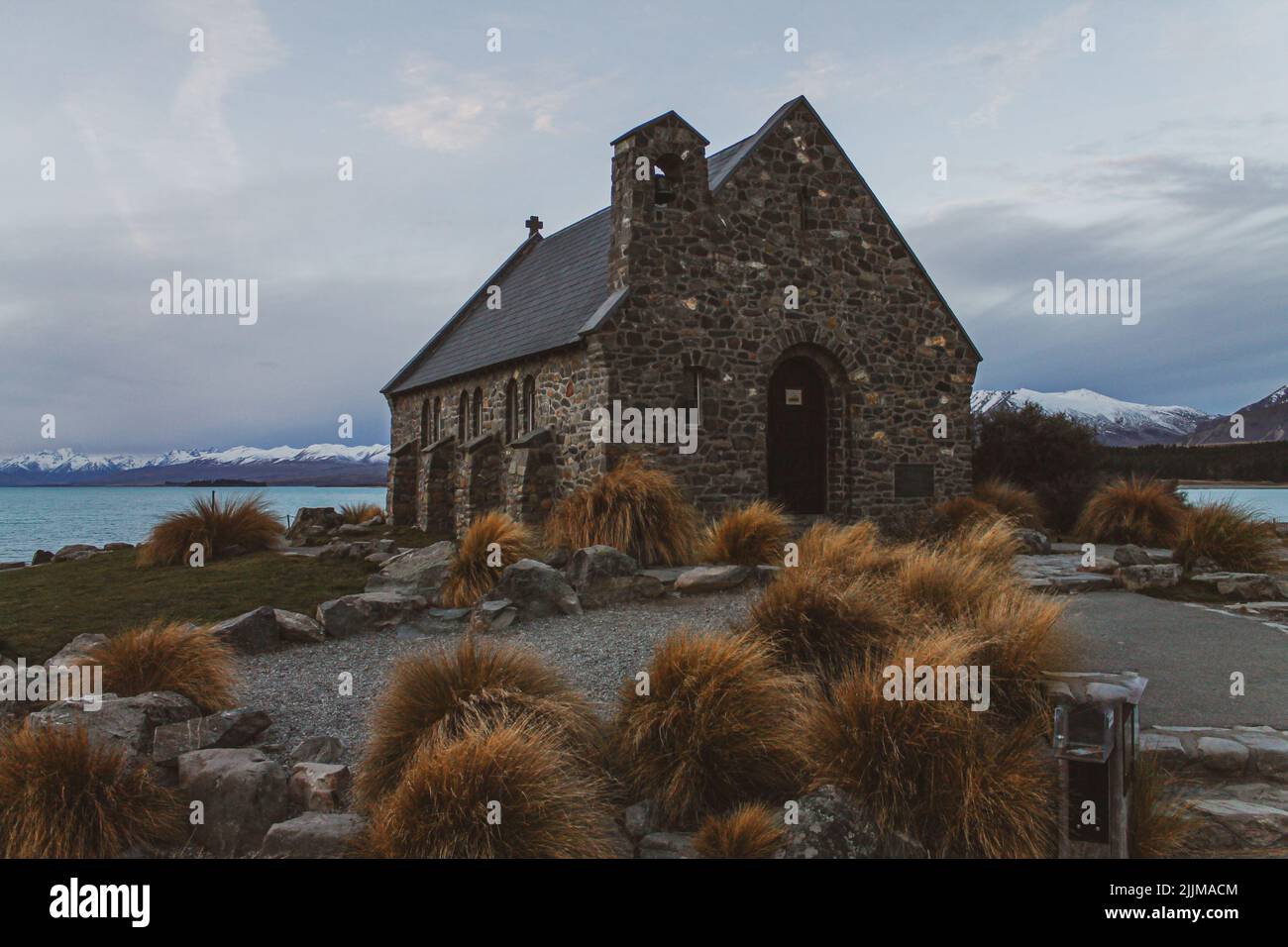 a low angle shot of old church near lake Stock Photo - Alamy