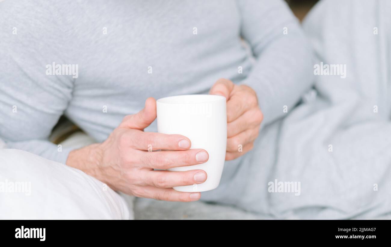 morning tea beverage man bed hold cup Stock Photo