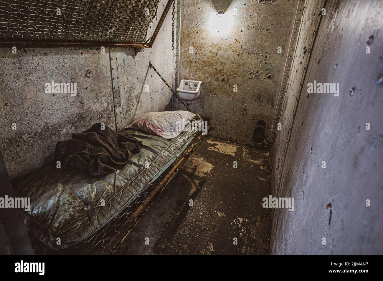 A high angle shot of an old abandoned jail cell room Stock Photo