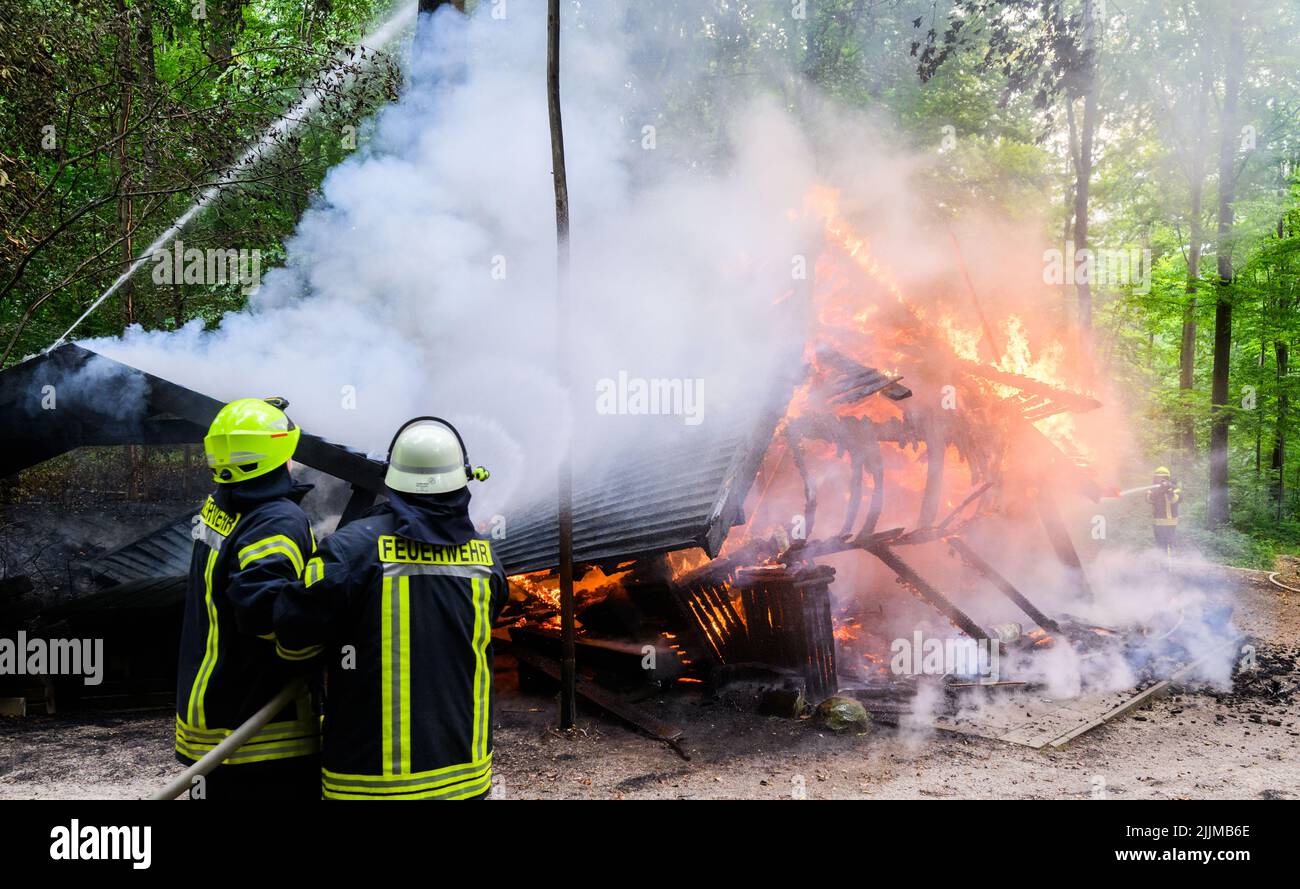 Salzhemmendorf, Germany. 27th July, 2022. Firefighters extinguish a ...
