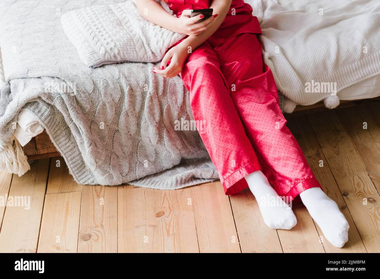 smartphone addiction woman pyjamas bed smartphone Stock Photo