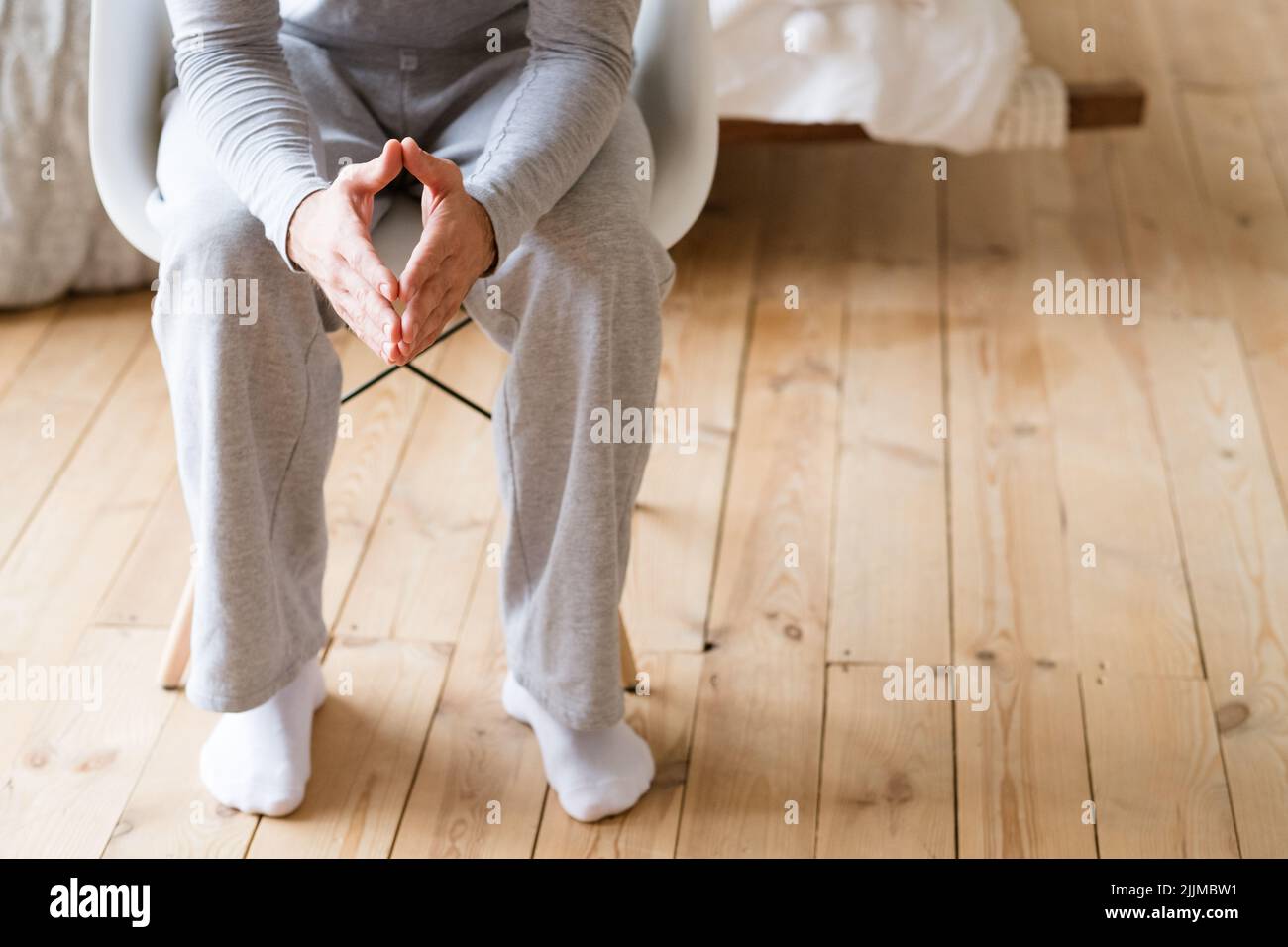 take decision man pyjamas sit steepling hands Stock Photo