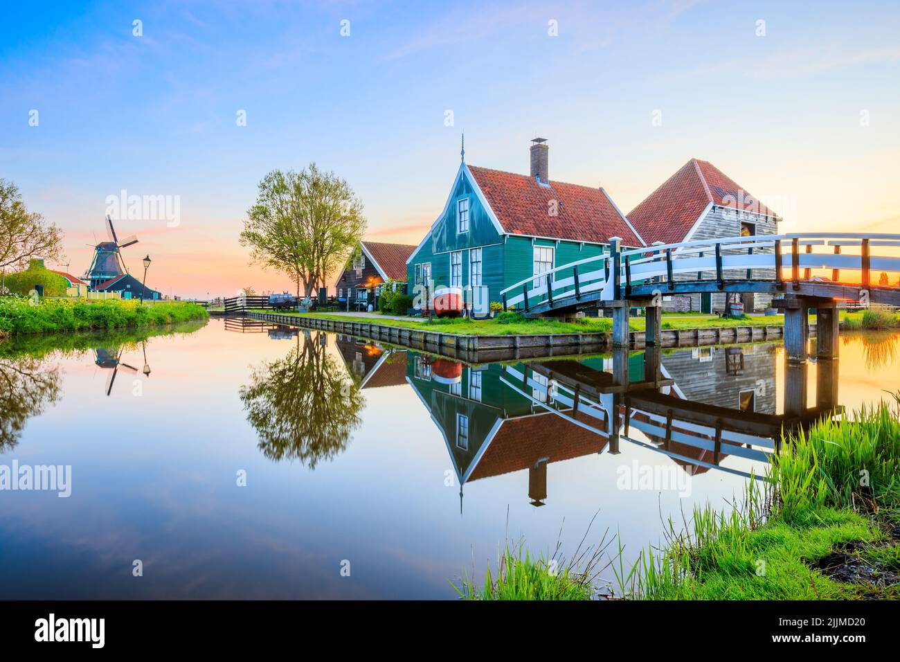 Zaanse Schans village, Netherlands. Dutch windmill and traditional house at sunrise. Stock Photo