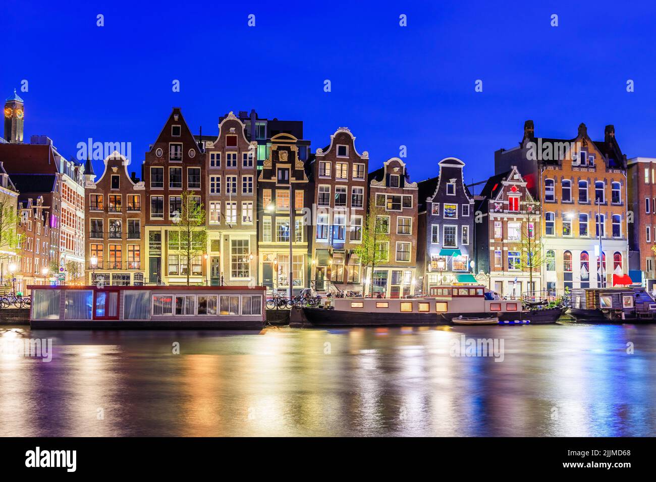 Amsterdam, Netherlands. Colorful dancing houses at the Damrak canal. Stock Photo