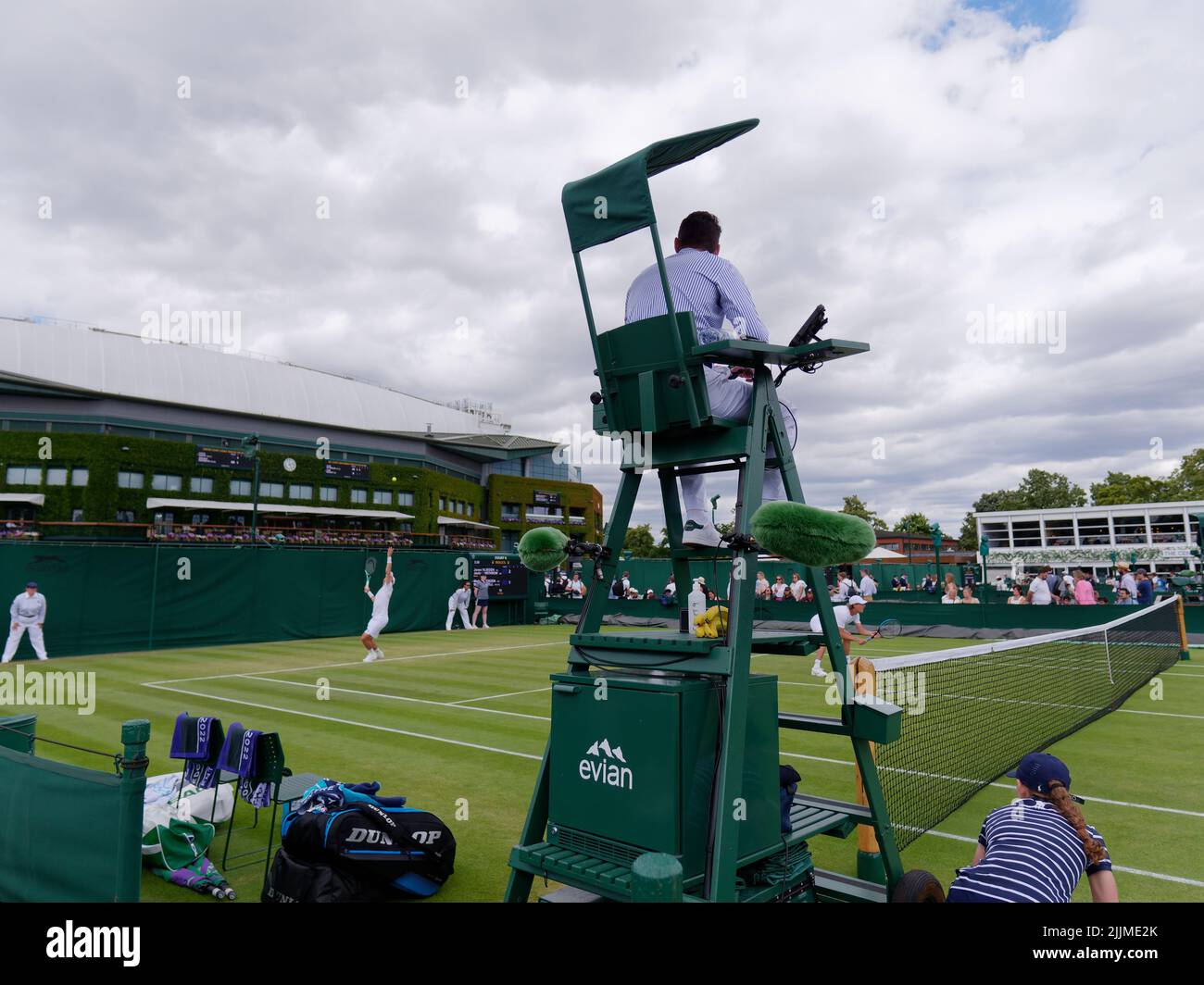 Wimbledon, Greater London, England, July 02 2022: Wimbledon Tennis Championship. Player serves during a doubles match with the umpire centre of image. Stock Photo