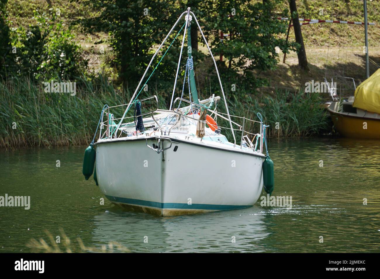 Sailboat swimming with en engine - front view Stock Photo - Alamy