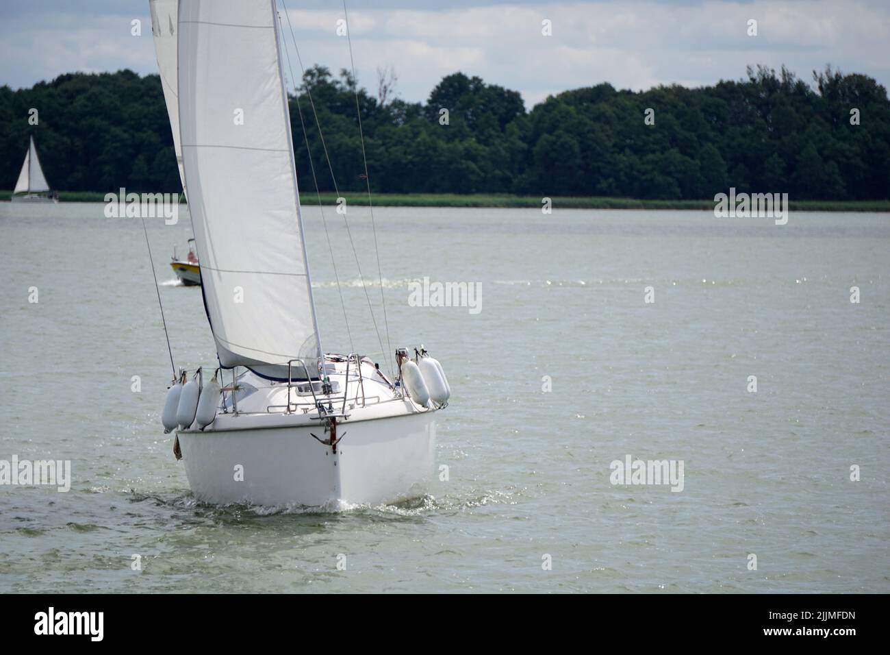 Sailboat Swimming On A Lake Front View Stock Photo Alamy