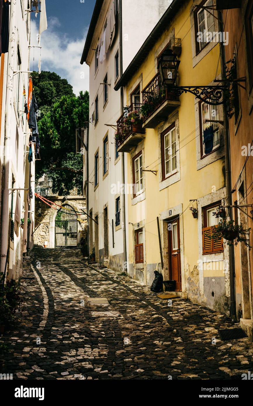A vertical shot of a narrow street in Lisbon, Portugal Stock Photo