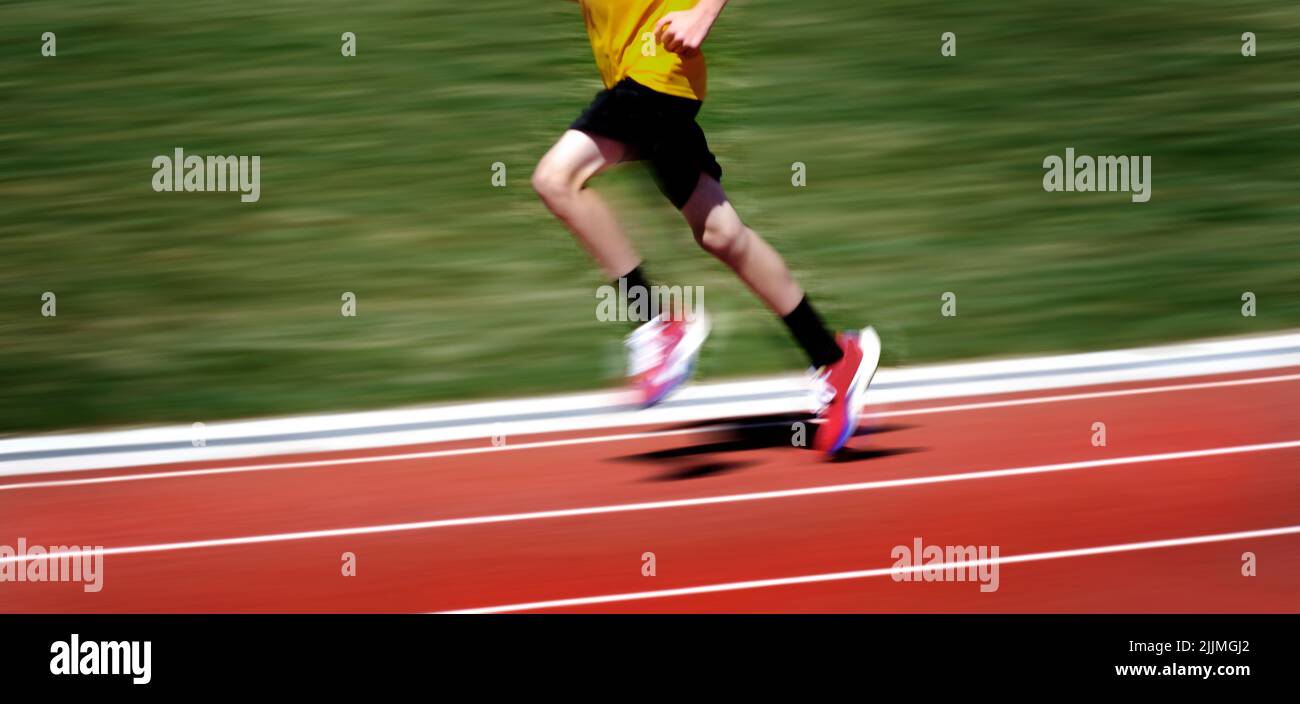 Person running a race on a track fast with speed competition Stock Photo